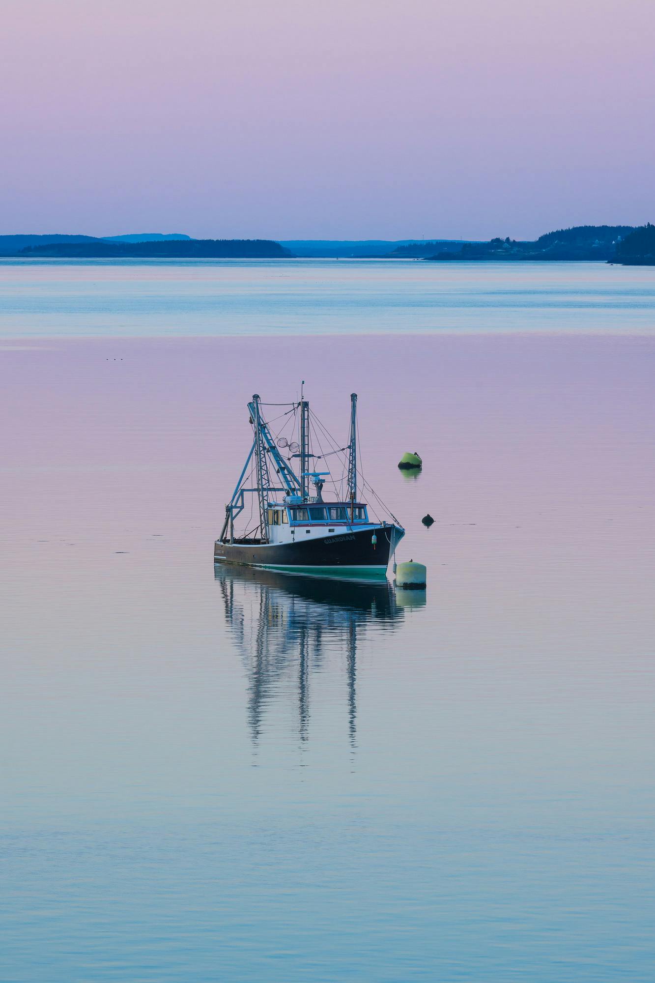 The Guardian Fishing Boat and Pastel Sunset